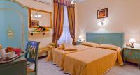 a bedroom with a bed and a table and a chair at Hotel Henry in Venice