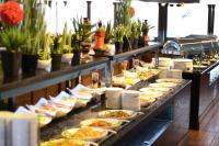 a buffet line with plates of food on display at Qasr Al Sahab in Khamis Mushayt