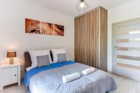 Łóżko lub łóżka w pokoju w obiekcie Gdansk Comfort Apartments Bursztynowa