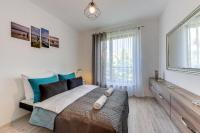 Łóżko lub łóżka w pokoju w obiekcie Gdansk Comfort Apartments Bursztynowa