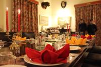 a long table with red and yellow napkins on it at Brijraj Bhawan Palace Hotel in Kota