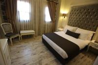 A bed or beds in a room at L'Agora Old Town Hotel & Bazaar