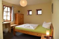 a bedroom with a bed and a desk and a window at Landhotel Edelhof in Uhlstädt