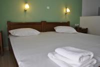 A bed or beds in a room at Filoxenia Hotel & Apartments