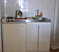 A kitchen or kitchenette at Filoxenia Hotel & Apartments