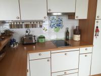 a kitchen with white cabinets and a counter top at Villa Bellochio in Menton