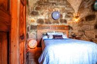 a bedroom with a bed in a stone wall at Hostal El Asturiano in Tarifa