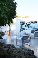a group of white couches sitting in a courtyard at Hotel Años 50 in Torremolinos