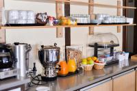 a kitchen counter with a blender and fruit on it at Hotel Atlantique in Mimizan-Plage