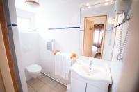 a white bathroom with a sink and a toilet at Hotel Atlantique in Mimizan-Plage