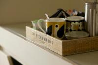 two coffee mugs in a wooden tray on a counter at The Plume of Feathers in Mitchell