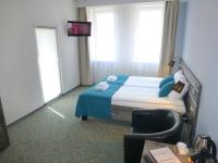 Łóżko lub łóżka w pokoju w obiekcie Hotel Giżycko