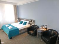 Łóżko lub łóżka w pokoju w obiekcie Hotel Giżycko