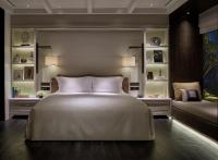 a bedroom with a large white bed and a couch at Rosewood Phuket in Patong Beach