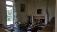 a living room with a fireplace and a couch at Manoir en Crau in Arles