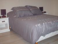 a bed with writing on it in a bedroom at Meublé de tourisme*** letrilogis in Joinville