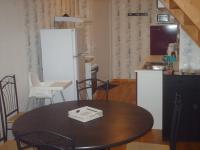 a kitchen with a table and a refrigerator at Meublé de tourisme*** letrilogis in Joinville