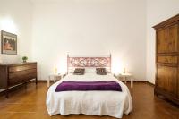 A bed or beds in a room at At Kalsa Quiet Flowered Terrace! Free Parking! Ideal for remote working!