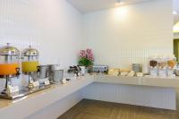 a kitchen with a counter with drinks and food at Hisea Huahin Hotel in Hua Hin