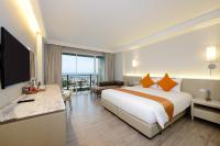 a hotel room with a large bed and a television at Hisea Huahin Hotel in Hua Hin