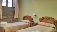 A bed or beds in a room at PICO SACRO II HOTEL Santiago de Compostela