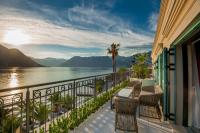 a balcony with chairs and a view of the water at Hotel Forza Terra in Kotor