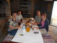 a group of people sitting at a table eating at Guest House Stara Baranja in Kneževi Vinogradi