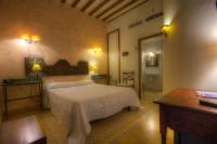 a bedroom with a white bed and a bathroom at Hotel Argantonio in Cádiz