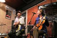 a man and a woman singing and playing instruments at Sundeck Hotel in Perisher Valley