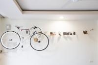a bike hanging on a wall in a room at Dali Yi International Hostel in Toucheng