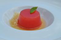 a red dessert on a white plate with a leaf on it at Bosco Ciancio in Biancavilla
