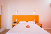 A bed or beds in a room at TheJoy City Suites