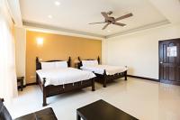 a bedroom with two beds and a ceiling fan at 百分百民宿 in Taitung City