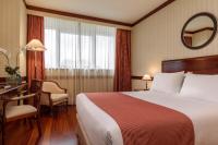 A bed or beds in a room at Eurostars Gran Hotel Santiago