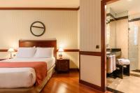 A bed or beds in a room at Eurostars Gran Hotel Santiago