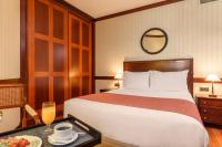 A bed or beds in a room at Eurostars Gran Hotel Santiago