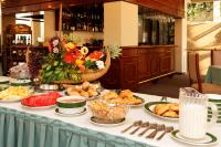 a buffet of food on a table with plates of food at Hotel Diplomat in Cochabamba