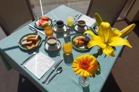 a blue table with breakfast foods and flowers on it at Hotel Diplomat in Cochabamba