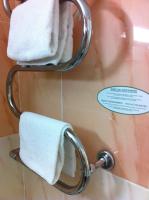 a towel rack with white towels in a bathroom at Les Palmiers in Fréjus