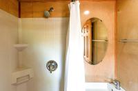 ein Bad mit einem Duschvorhang und einem Spiegel in der Unterkunft Tiny House in Austin
