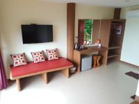 a living room with two benches and a flat screen tv at Moonstone Studio in Haad Rin