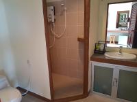 a bathroom with a shower and a toilet and a sink at Moonstone Studio in Haad Rin