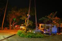 a house with christmas lights in a yard at night at Moonstone Studio in Haad Rin