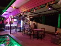 a restaurant with tables and chairs next to a swimming pool at Moonstone Studio in Haad Rin