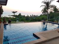 a swimming pool with a view of the ocean at Moonstone Studio in Haad Rin