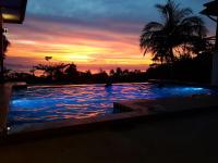 a large swimming pool with a sunset in the background at Moonstone Studio in Haad Rin