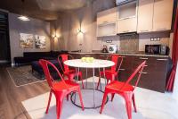 a kitchen with a table and red chairs in a room at Apartment near the sea in Gribovka