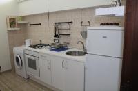 A kitchen or kitchenette at L'occhio sul Vesuvio appartamento con terrazza privata e casa vacanza senza terrazza privata