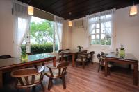 a dining room with tables and chairs and windows at Yilan Ya Lu Homestay in Datong