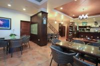a restaurant with tables and chairs and a bar at Yilan Ya Lu Homestay in Datong